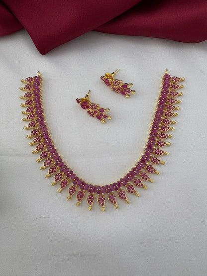 Bridal Wear Ruby-Tone CZ Short Necklace Set - South India Special - Full view of necklace and earrings on a – front view