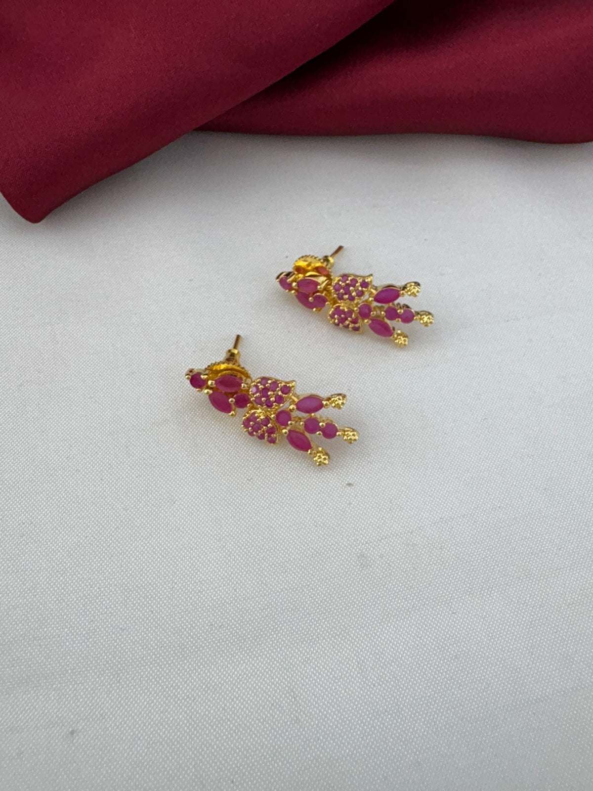 Bridal Wear Ruby-Tone CZ Short Necklace Set - South India Special - Close-up of ruby stud earrings on a white and – view 2