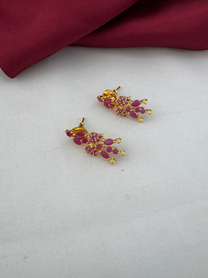 Bridal Wear Ruby-Tone CZ Short Necklace Set - South India Special - Close-up of ruby stud earrings on a white and – view 2