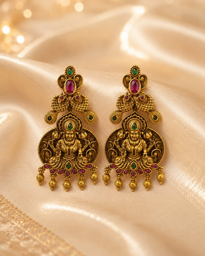 gold-plated ruby and emerald earrings styled with saree fabric for Indian occasion wear – view 3