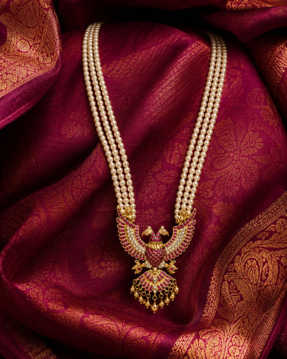 pearl-look strand peacock jadau kundan long haram necklace on jewellery display – view 2