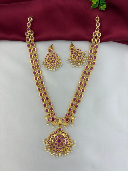 Royal Crimson Cascade Ruby Long Necklace and Earring Set. Features an angled view of the ornate pendant with – front view