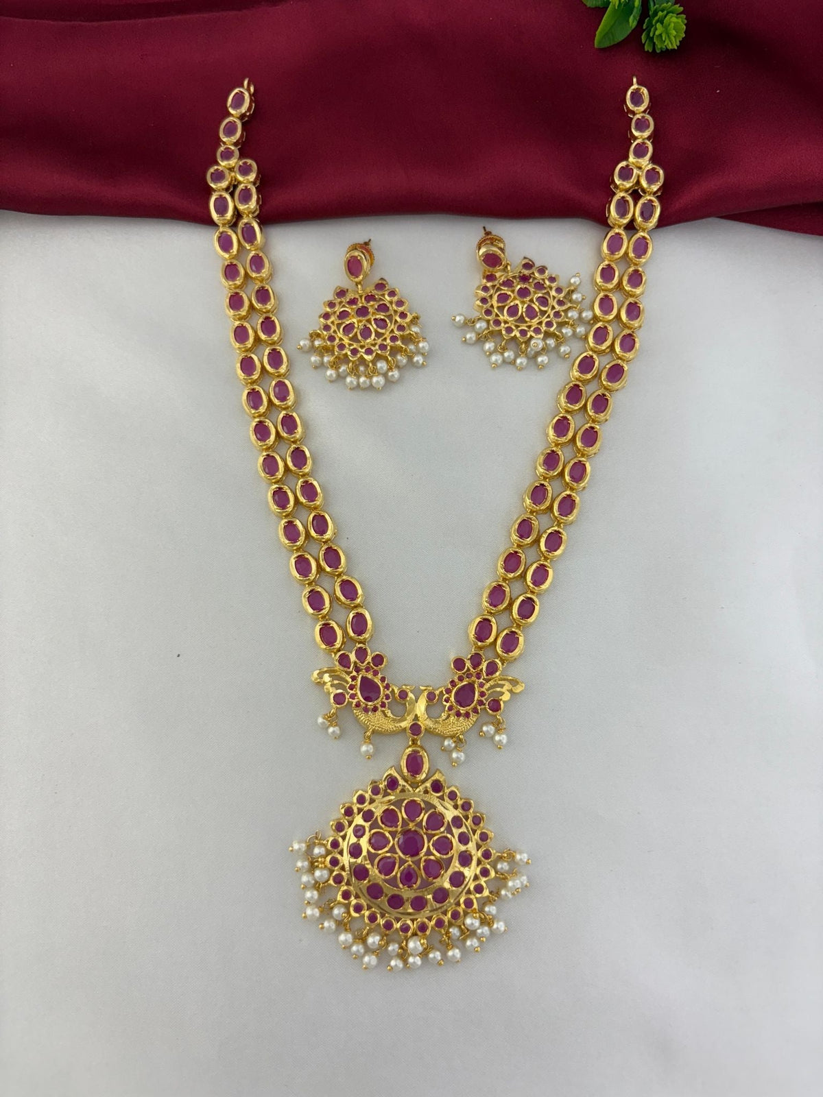 Top-down view of the Royal Crimson Cascade Ruby Long Necklace and Earring Set. Highlights the straight alignment of – view 2
