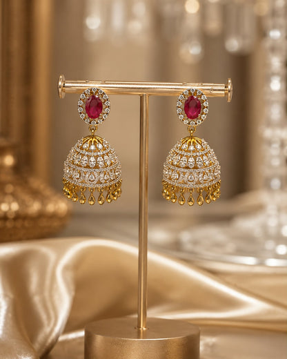 Ruby Ganga Jamuna CZ Jhumka Earrings with Leaf-Drop Fringe – ruby jhumka earrings on jewellery display – front view