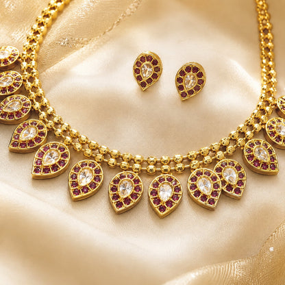 Ruby AD/CZ Necklace Set for Sarees & Receptions – ruby-tone necklace set with matching earrings on jewellery display – view 2