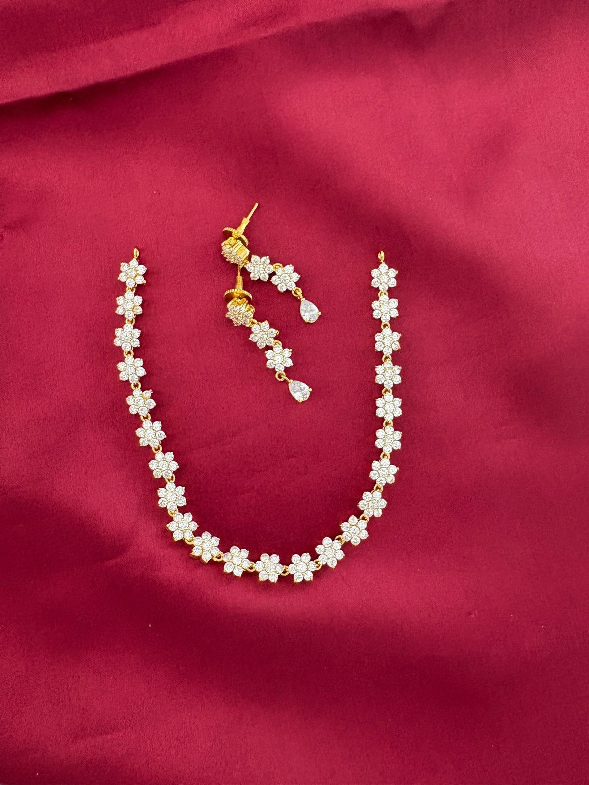 Solitaire Sparkle AD Stone Short Necklace Set with matching earrings, floral design, on maroon background – view 2
